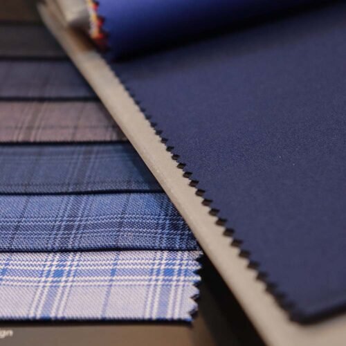 Blue fabric swatches for custom tailoring, showing textures and patterns used in Emporium Armani bespoke suits.